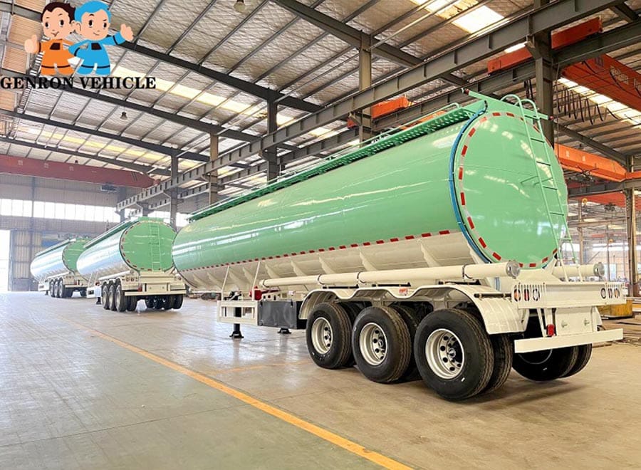 Green tanker trailer inside a workshop