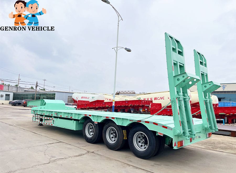 Green low bed semi trailer with a clear deck and raised rear loading ramps