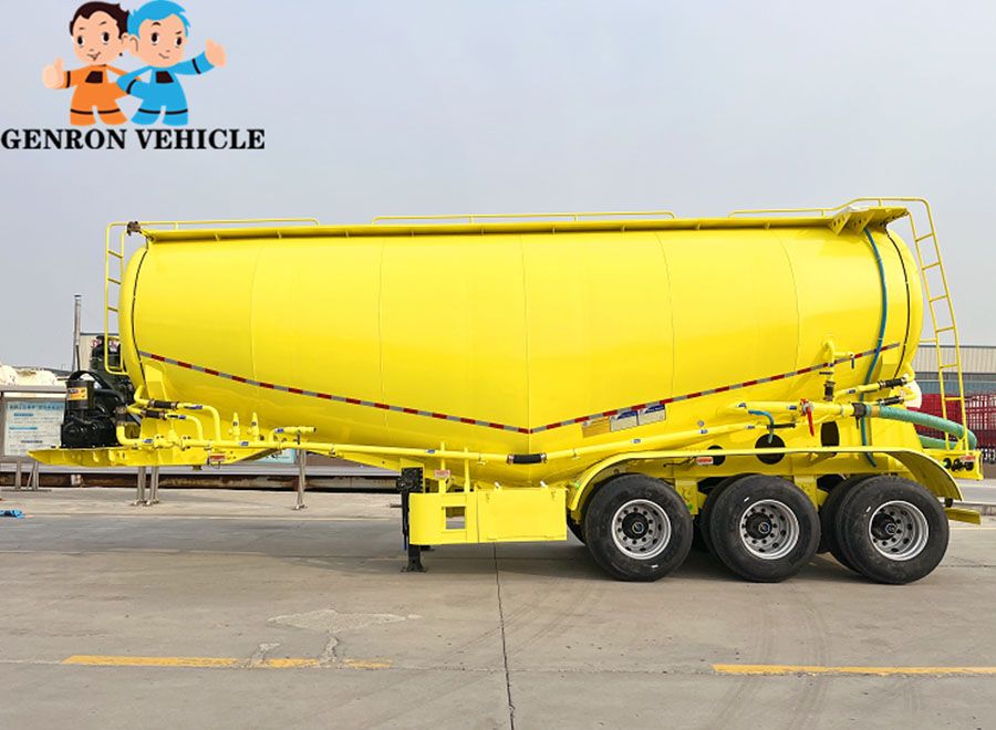 Yellow three-axle bulk cement tanker viewed from the side
