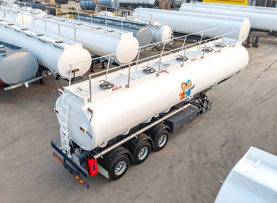 Overhead view of a white fuel tanker trailer with top access covers