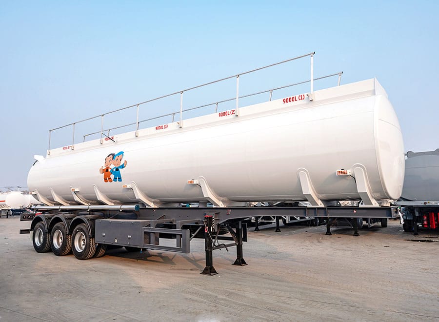 Side view of a white tanker trailer in a yard