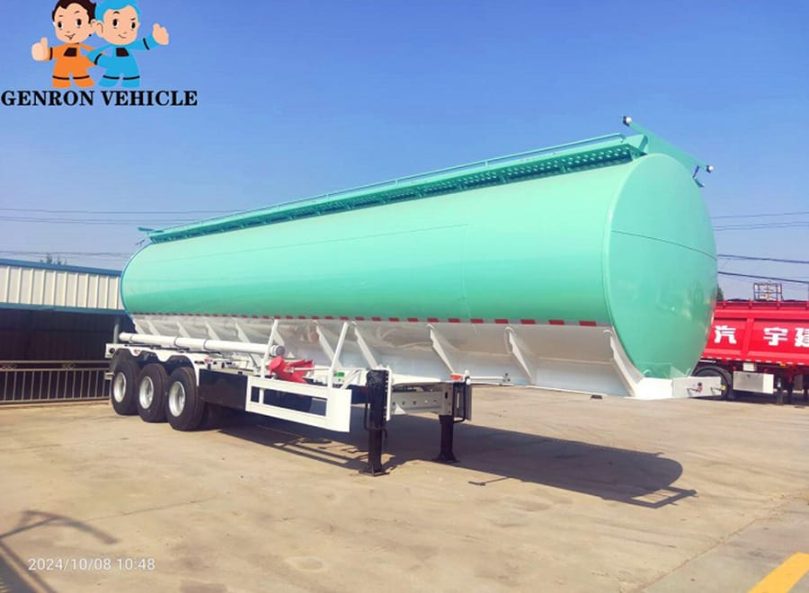 Green fuel tanker semi trailer on landing legs in a yard