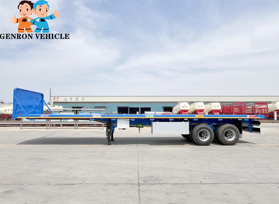 Blue flatbed semi trailer with an open deck and front headboard