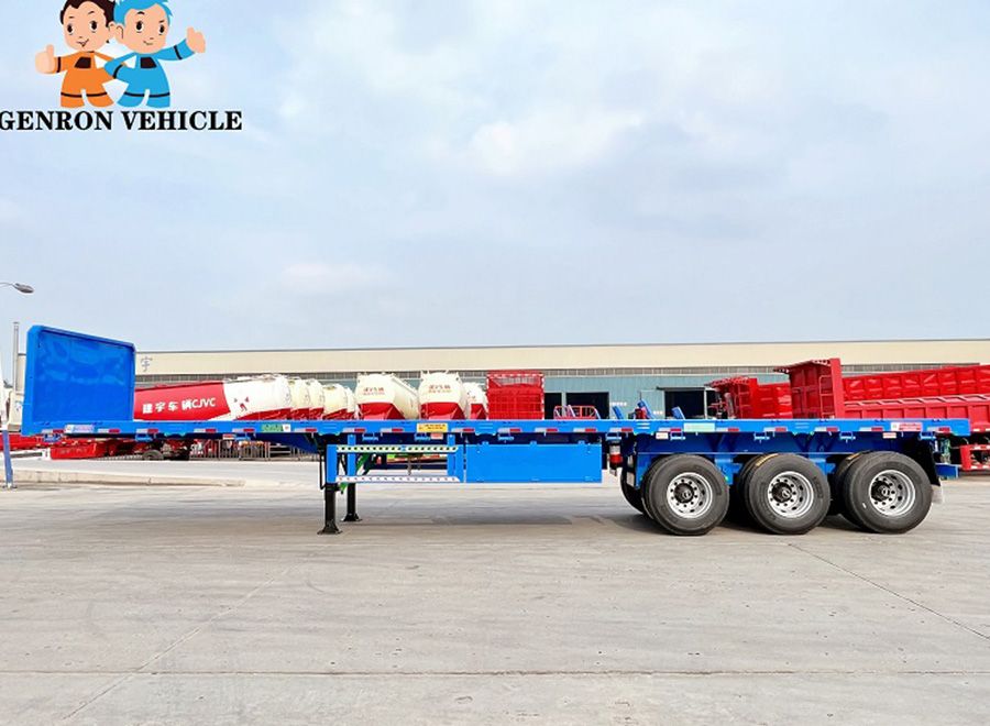 Blue three-axle flatbed semi trailer viewed from the side