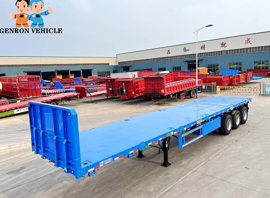 Blue three-axle flatbed trailer viewed from above in the factory yard