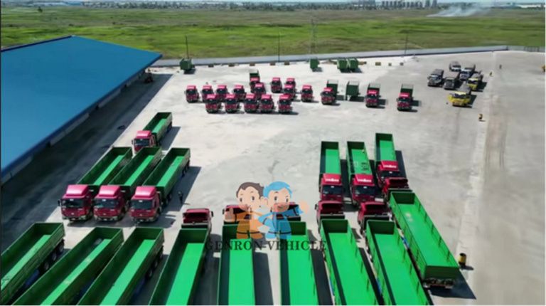Rows of trucks and open-body trailers in a vehicle yard