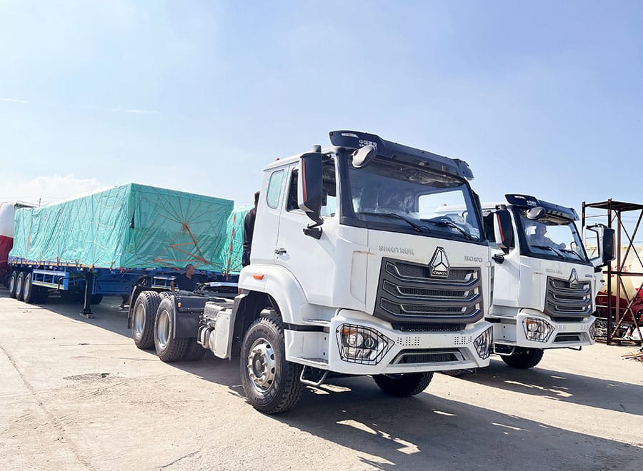White HOWO tractor truck with its rear chassis visible in a yard