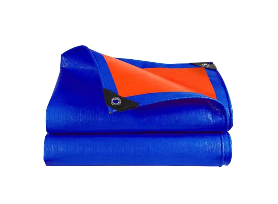 Folded blue tarpaulin with an orange section and metal eyelet
