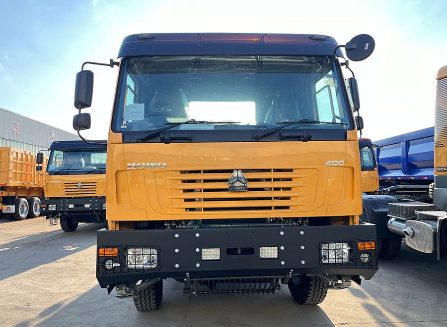 Front view of a yellow HOWO tractor truck in the yard